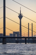 Sunset on the Rhine near Düsseldorf, skyline of the city centre with Rhine Tower, Rheinkniebrücke,