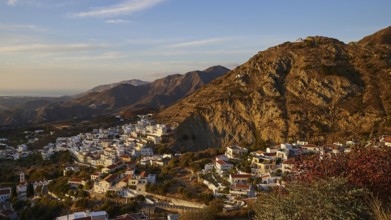 An expansive view of a village in the mountains under a blue sky, mountain villages of Aperi and