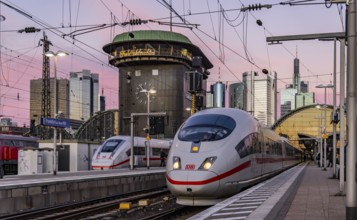 Frankfurt main station with ICE in the evening, sunset. View of platform and banking district,