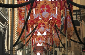 Flags decorate historic street in city centre of Valletta, Malta, Europe