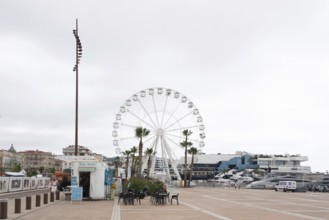 A Ferris wheel stands in the harbour of Cannes, Provence-Alpes-Côte d'Azur, France, Europe