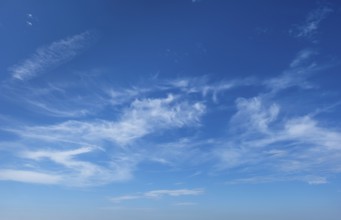 Clear Blue Sky with Wispy Clouds on a Sunny Day, Nature, Weather, and Serenity