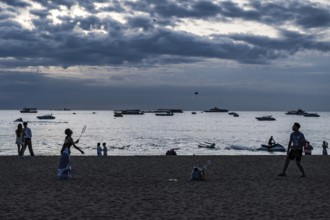 Couple playing badminton on the beach