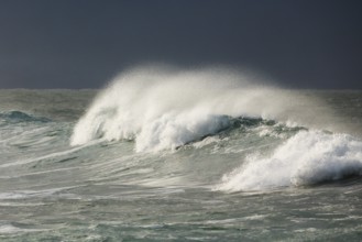 Big wave breaks in the open sea on the Breton coast near Brest, France, Europe