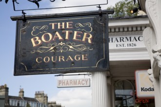 The Boater pub and pharmacy sign in Argyle Street, Bath, Somerset, England, United Kingdom, Europe