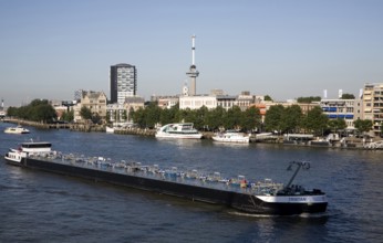 River barge chemical transporter ship 'Tristan' passing Euromast in the city, River Maas, Port of