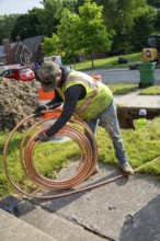 Detroit, Michigan, Workers replace old lead water service lines with copper pipes. Lead is harmful