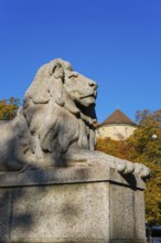 Resting lion made of granite on the terraced base of the equestrian statue of Emperor Wilhelm I on