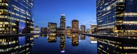 Glass surface facade mirroring an iconic skyline in evening light, AI generated