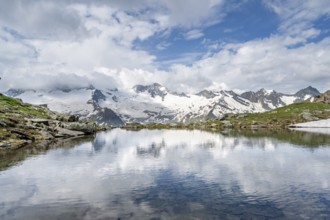 Picturesque mountain landscape with mountain lake, mountains and glaciers reflected in the