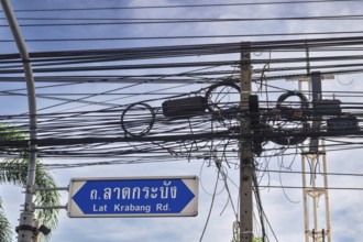 Power lines signpost Lat Krabang Road, Bangkok, Thailand, Asia