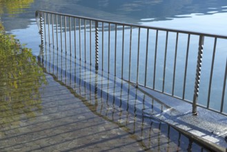 Street with Railing on Flooding lake Maggiore on the Waterfront in a Sunny Day with Sunlight in