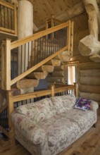 High angle view of twisting staircase with wooden and black wrought iron handrail and brown stained