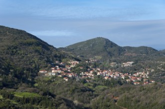 Idyllic view of a village with orange-coloured roofs and lush vegetation, Andritsena,