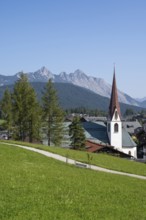 View of the village with St Oswald parish church, Karwendel mountains, view from the parish hill,