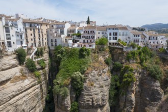 Spanish town with white houses in it situated above a spectacular gorge, view from El Puente Nuevo,