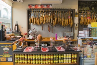 Spanish butcher's shop with a large selection of hung hams and fine sausage specialities, old town,