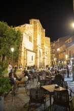 Restaurants on the Plaza Mayor at night, behind the Romanesque church Iglesia de San Juan de Puerta