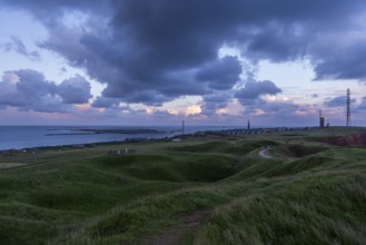 Wavy upland of the offshore island Helgoland with dune, lighthouse, radio tower, hiking trail,