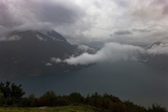 Aerial View over Lake Lugano in Valley with Mountainscape with Storm Clouds in Lugano, Ticino,