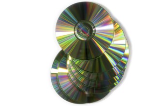 A pile of glittering CDs stacked on top of each other, white background