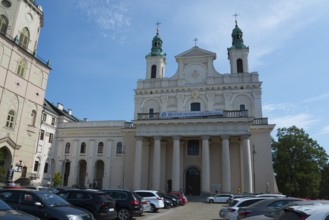 Large church with columned façade and parked cars in front, St John's Cathedral, Lublin, Poland,