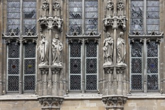 Historic town hall Stadhuis, partial view of the façade in Flamboyant Gothic style with sculptures,