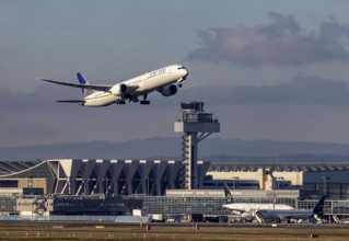 Aircraft taking off in front of the hangar and tower at Fraport Airport. Aircraft registration