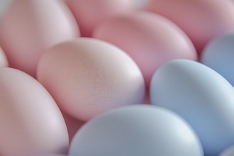 Close up of pastel blue and pink easter eggs. Generative AI, AI generated