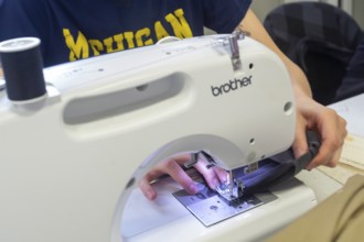 Detroit, Michigan - Volunteers repair various items during the monthly Repair Cafe at the Knapp