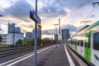 Regional train arriving at Essen central station, platform, city centre skyline, North