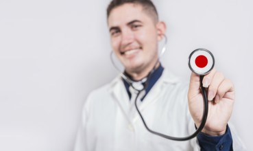 Happy doctor showing stethoscope with Japan flag. Japan National Healthcare concept