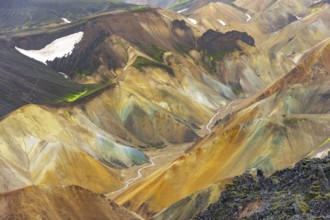 Small river between colourful rhyolite mountains, volcanic landscape, erosion landscape, view from