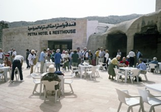 Tourists of a Hellenic tour group in front of a hotel and a service area in Petra, Jordan, 1998,