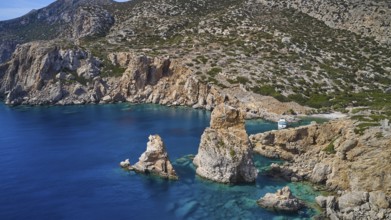 Palatia Beach, Palatia, cliff landscape with offshore rocks and a boat in the clear water, boat