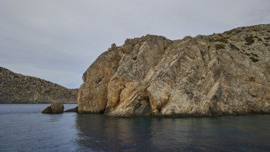 Massive rocks on the water, the sea is calm and the sky is slightly cloudy, boat tour Saria, Saria