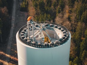 Detailed view of a wind turbine high above an autumnal forest, wind turbine construction, Calmbach,