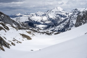 Lone ski tourer, Snowy mountain landscape, Bernese Alps, Bernese Oberland, Switzerland, Europe