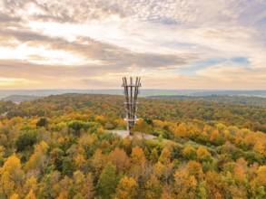 Imposing tower rises above the colourful autumn forest under a vibrant sky, Schönbuchturm,