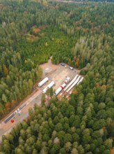 Construction site in the forest with wind power components surrounded by colourful autumn leaves,