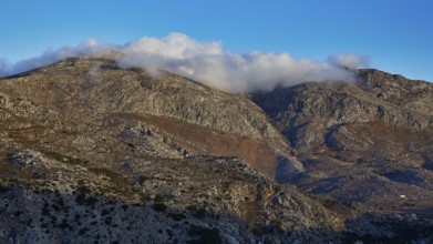 Mountain landscape with clouds floating on the peaks, under a blue sky, Morning mountain landscape,