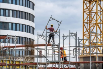 Construction site, construction of an office building, scaffolding, concrete worker, Düsseldorf,