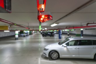 Underground car parks, multi-storey car parks, red or green lamps on the ceiling, show drivers