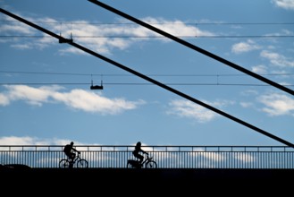 Cyclist, on the Rheinknie Bridge in Düsseldorf, North Rhine-Westphalia, Germany, Europe