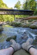 The Irrel Waterfalls, rapids in the lower reaches of the Prüm, covered wooden bridge for hikers,