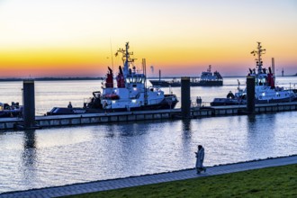 The tugboat pier, harbour tugs waiting for their next assignment, at the New Harbour, sunset over