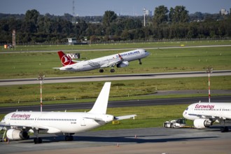 Düsseldorf Airport, Turkish Airlines Airbus A321 on take-off, Eurowings Airbus in parking position