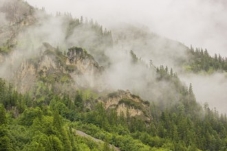 Wisps of mist cover the Karwendel mountains in the Großer Ahornboden nature reserve, Eng Valley,