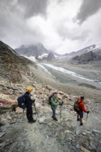 Group of mountaineers descending from Col de Riedmatten, view of glacier Glacier de Cheilon and