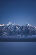 Shortly after sunset, twilight at Lake Hopfensee in the Allgäu in Bavaria in a winter landscape,